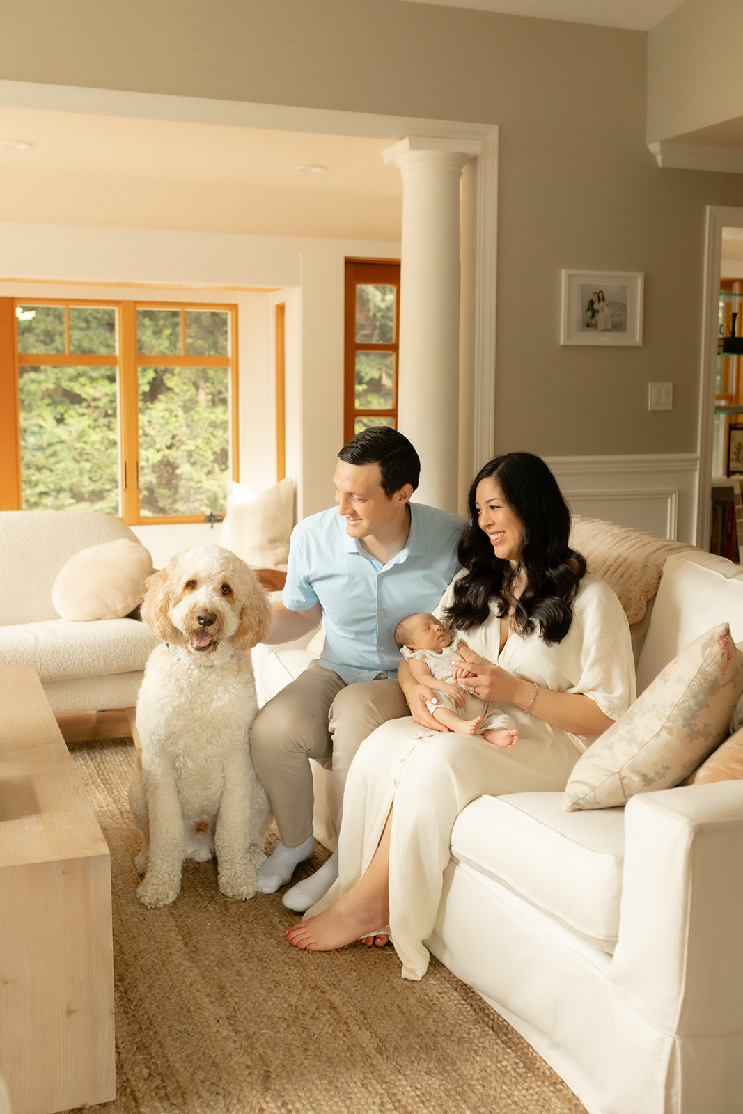Family relaxing with their newborn and dog during a lifestyle newborn photography session at home in Seattle.